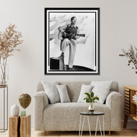 Josh White, full-length portrait, standing, facing right, holding guitar.photo by Albert A. Freeman. Classic, Vintage Poster