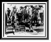 Howard Hughes, full-length portrait, seated, facing front, film crew in background, during filming of Sky devils"" Classic, Antique Print