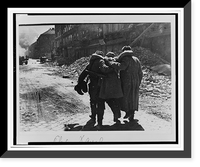 Wounded Soviet soldier being helped by two comrades down a street filled with rubble, Vienna.Evgenii Khaldei. Classic, Vintage Print