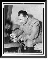 Hermann G&ouml;ring, three-quarter length portrait, seated on bed(?), facing left, eating from pan.U.S. Army Signal Corps, Vintage Poster