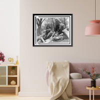 Historic Framed Print, [FSA staff members John Collier, reclining, and Jean Lee, eating an apple, taking a break out-of-doors],  17-7/8" x 21-7/8"