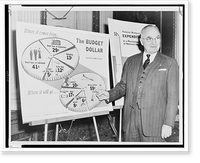 Harry S. Truman, half-length portrait, standing next to budget charts for 1954, during press conference, Antique Poster