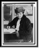 Historic Framed Print, [Frances Perkins, half-length portrait, facing front, signing document],  17-7/8" x 21-7/8"