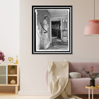 Young woman in colonial dress on steps in Colonial- American home, Historic Reproduction
