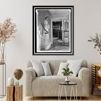 Young woman in colonial dress on steps in Colonial- American home, Historic Reproduction