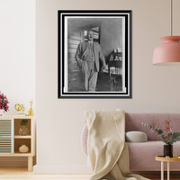 John Ford, three-quarter length portrait, standing, facing slightly right, with his left hand on rolltop desk, Antique Poster
