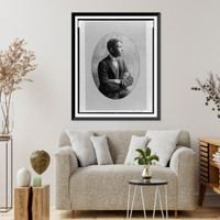 Young African American man, half-length portrait, seated with arms crossed, right profile, Antique Poster