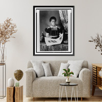 African American girl, half-length portrait, standing at table with illustrated book, facing slightly right, Antique Poster