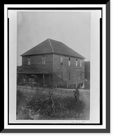 Exterior view of large unidentified building in Georgia, with a man standing in front holding an umbrella, and a group of children sitting on the porch, Antique Poster
