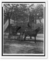 African American man (doctor?), carrying small leather bag, standing on steps to residence, horse-drawn carriage in the foreground, Historic Print