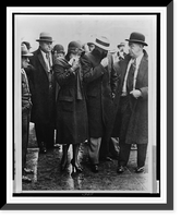 Mr. and Mrs. Vincent Coll, full-length portrait, walking through a crowd with their faces covered after being released from court, Historic Reproduction