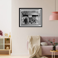 Historic Framed Print, [A New York City policeman standing in front of the New York City drugstore where gangster Vincent Coll was murdered],  17-7/8" x 21-7/8"