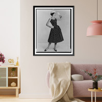 A fashion model posed in a polka dot sun dress and straw hat Classic, Historic Reproduction