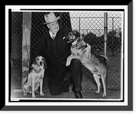 Frank W. Boykin, full-length portrait, kneeling, facing left, holding two dogs, Historic Reproduction