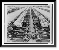 Rows of 40mm Bofors light anti-aircraft(?) guns on Mark II mountings sitting beside railroad tracks in England, in preparation for Allied liberation of Europe, Antique Print