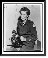 Historic Framed Print, [Toni Frissell, half-length portrait, seated, facing slightly left, in Red Cross uniform, holding camera],  17-7/8" x 21-7/8"