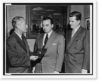 Paul M. Hahn accepts, on behalf of The American Tobacco Company, TV Guide's Gold Medal award for the television commercial of the year from Lee Wagner as A.R. Stevens looks on Timeless Wall Art P