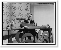 Steve Allen, full-length portrait, facing front, seated at table during his television program, Historic Reproduction