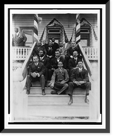 Booker T. Washington, seated on steps, with group of other men, outside of building, Vintage Poster