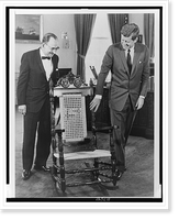 President John F. Kennedy examines mahogany rocking chair given by Dominican Republic, as Foreign Minister of the Dominican Republic Dr. Jos&eacute; A. Bonilla Atiles (l) looks on - 2 Heritage Wa
