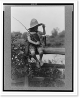 Reference prints from negatives.Doris Gottscho, holding fish and fishing pole, sitting on a fence III, Historic Reproduction