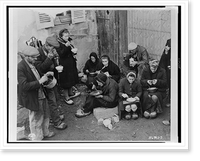 French refugees of the town of the Corcieux, France, eat their noon meal in a courtyard.Signal Corps U.S. Army. Classic, Antique Print