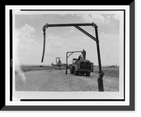 View of tank truck getting fuel from pipe to refuel airplane(?), Italy, Historic Reproduction