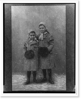 Anna and Sophie Freud, full-length portrait, standing, facing front, wearing coats and muffs.Dr. H. Heid, Wien, Vintage Print