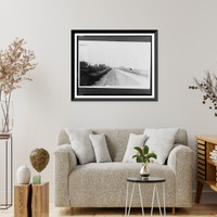 Historic Framed Print, [Rural area with houses and other buildings lining both sides of road, field on right lies fallow],  17-7/8" x 21-7/8"