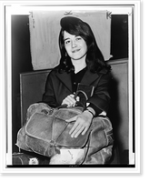 Martha Argerich, full-length portrait, facing front, seated, holding luggage, at Pier 86, after having arrived on the liner Constitution.World Telegram & Sun photo by Dick DeMarsico. Antique Wall