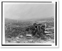 Unidentified old man, seated, writing, at entrance to a log and earth shelter in Alaska, 1899.Curtis, Antique Print