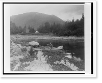 A man, possibly Lewis Rutherford Morris, seated in a canoe on a river in Alaska, 1899.Curtis, Antique Print