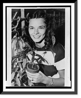 Nancy Champlin, head-and-shoulders portrait, facing front, holding plant used to synthesize cortisone, a drug used to treat rheumatic fever, from which she suffers, Vintage Wall Art