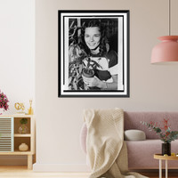 Nancy Champlin, head-and-shoulders portrait, facing front, holding plant used to synthesize cortisone, a drug used to treat rheumatic fever, from which she suffers, Vintage Wall Art