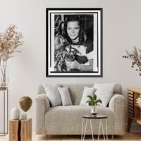 Nancy Champlin, head-and-shoulders portrait, facing front, holding plant used to synthesize cortisone, a drug used to treat rheumatic fever, from which she suffers, Vintage Wall Art