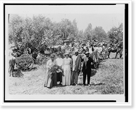 Portrait of three African American women and two men, behind them is a large group of African Americans in horse-drawn carriages and wagons in open area with trees on the left Heritage Wall Art P