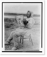 Historic Framed Print, Eskimo reading Saturday Evening Post in the arctic region,  17-7/8" x 21-7/8"
