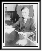Historic Framed Print, [Henry A. Wallace, half-length portrait, facing front, seated at desk, posed holding pen],  17-7/8" x 21-7/8"