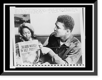 Historic Framed Print, Cassius Clay points to newspaper headline to prove that he's not the only one protesting the Viet Nam war,  17-7/8" x 21-7/8"