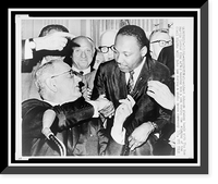 Historic Framed Print, President Johnson shakes hands with The Rev. Martin Luther King after handing him a pen during the signing of the Civil Rights bill into law during a White House ceremony 7/2,  17-7/8" x 21-7/8"