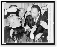 Historic Framed Print, President Johnson shakes hands with The Rev. Martin Luther King after handing him a pen during the signing of the Civil Rights bill into law during a White House ceremony 7/2,  17-7/8" x 21-7/8"