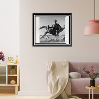Historic Framed Print, [Paul Rudolph, full-length portrait, seated outdoors on driftwood, Siesta Key, Sarasota, Florida],  17-7/8" x 21-7/8"