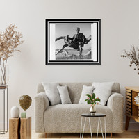 Historic Framed Print, [Paul Rudolph, full-length portrait, seated outdoors on driftwood, Siesta Key, Sarasota, Florida],  17-7/8" x 21-7/8"