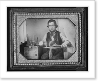 Historic Framed Print, [Occupational portrait of a blacksmith, three-quarter length, working on a horseshoe at an anvil, other tools to his side],  17-7/8" x 21-7/8"