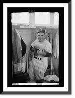 Historic Framed Print, [New York Yankee baseball player Yogi Berra, three-quarter length portrait, in uniform, in the locker room].Marvin E. Newman.,  17-7/8" x 21-7/8"