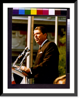 Historic Framed Print, [Ronald Reagan, half-length portrait, standing at microphones, facing left].photography by Marcia Dente. - 2,  17-7/8" x 21-7/8"