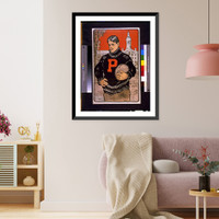 Historic Framed Print, [Princeton student, with letter P on sweater, half-length, standing, facing left, holding football(?), with Princeton University behind him].John E. Sheridan.,  17-7/8" x 21-7/8"