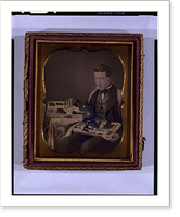Occupational portrait of a salesman, three-quarter length, seated, displaying his wares - 2 Classic, Vintage Print