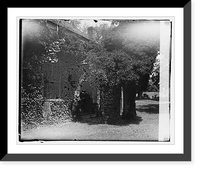 Man standing by the doorway of an old vine-covered building, Historic Print