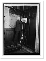 Historic Framed Print, Cannon removing picture from wall, 3/3/23,  17-7/8" x 21-7/8"